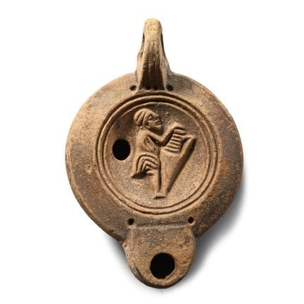 Roman Terracotta Oil Lamp with Figure Carrying an 
