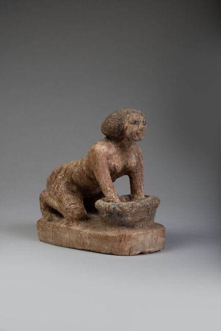 Statuette of a woman at work.
A free-standing stat