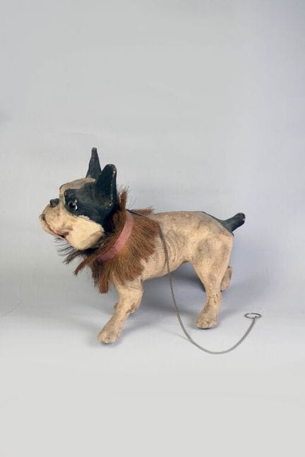 A barking bulldog made of papier-mâché and painted