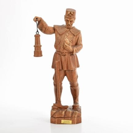 Wood, intricately carved, natural finish; a miner 