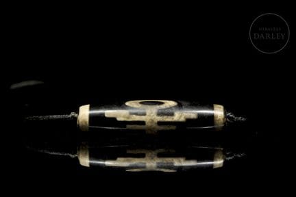Ritual bead, made of black agate with engraved dec