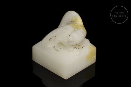 White jade with subtle amber-colored flecks, carve