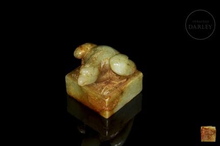 A yellow jade seal with ochre and reddish veins, t