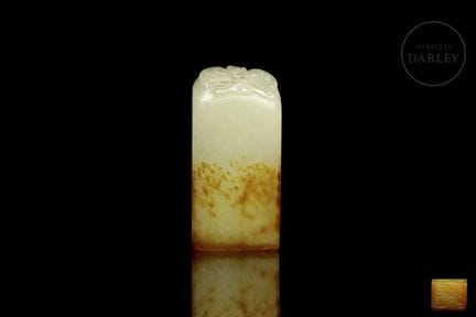 A rectangular seal carved from jade in a soft ochr