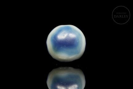 Lenticular agate bead with a transverse perforatio