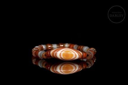 A bracelet consisting of a series of cylindrical, 