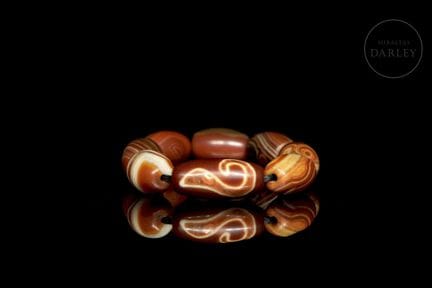 A ceremonial bracelet composed of eight cylindrica