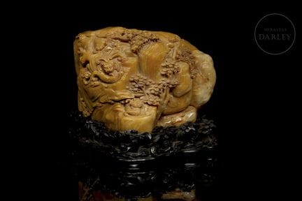A sculpture carved from orange-hued Shoushan stone