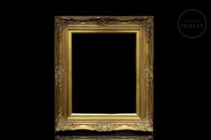 Carved and gilded wooden frame with rich relief or