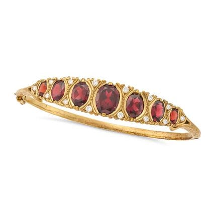 NO RESERVE -A GARNET AND DIAMOND BANGLE the hinged