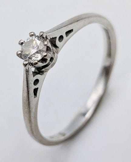 An 18K White Gold and Diamond Solitaire Ring. 0.15