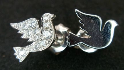 A pair of 18k white gold assymetric diamond dove s