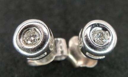 A Pair of 9K White Gold and Diamond Stud Earrings.