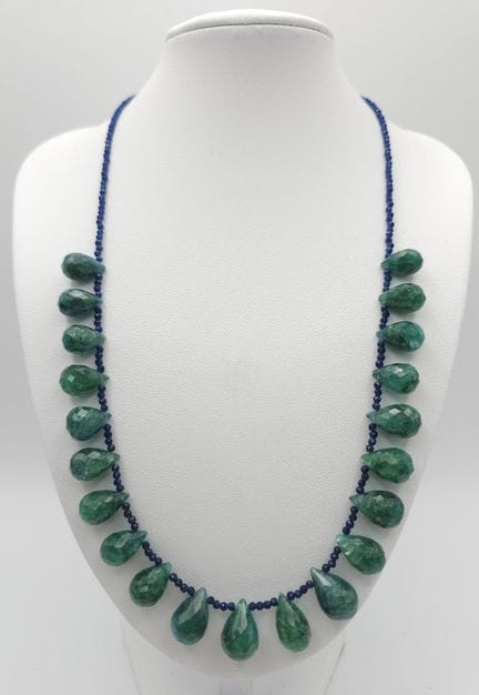 An Emerald Drop Necklace with Blue Beads. 131ct em