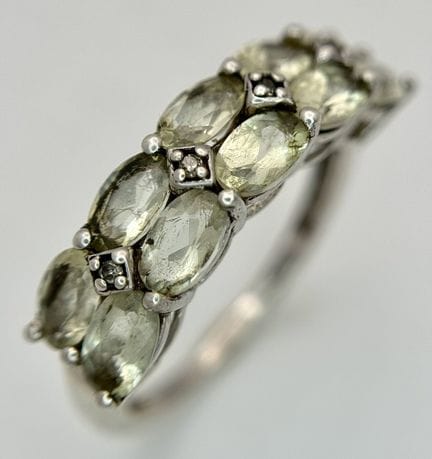 A Sterling Silver Double Row Pale Peridot and Diam