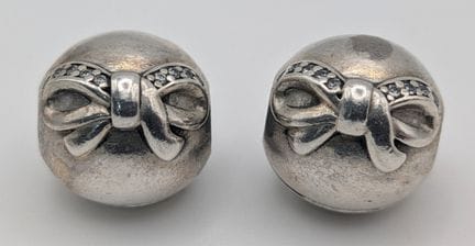 A pair of matching silver Pandora spacer charms, f