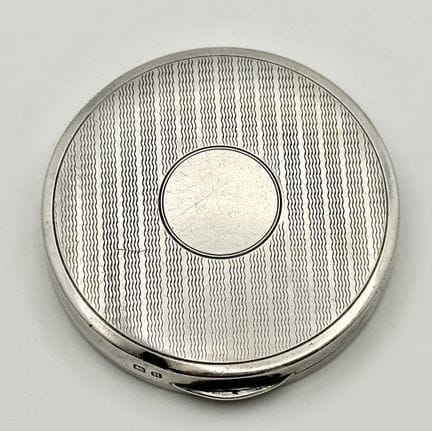 A Vintage Sterling Silver Cased Compact. 5cm diame