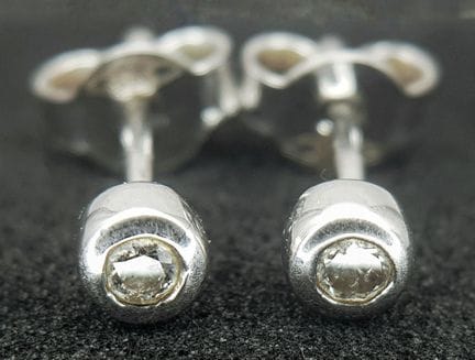 A Pair of 9K White Gold Diamond Stud Earrings. App