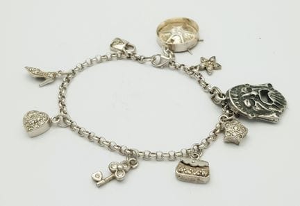 A 925 Silver Charm Bracelet. Nine charms including