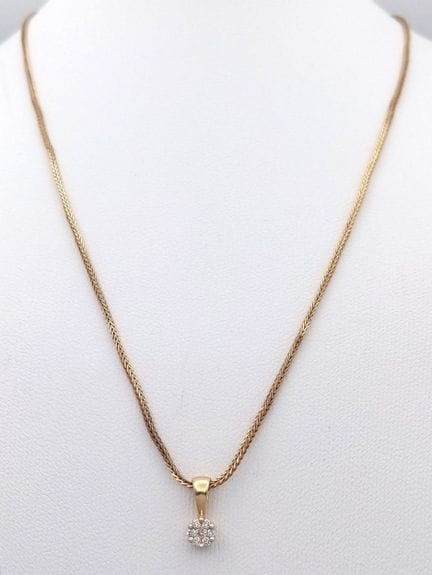 An 18K Yellow Gold Diamond Cluster Pendant on a 9K