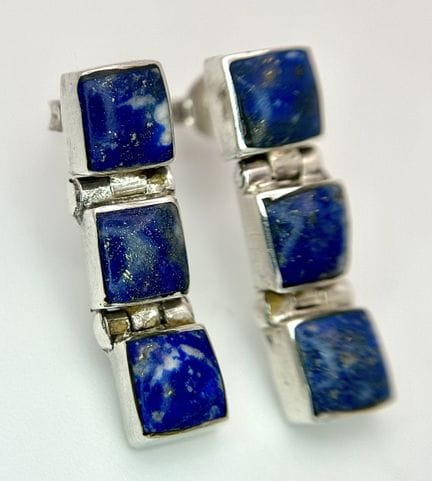 A collection of three pairs of silver stud earring