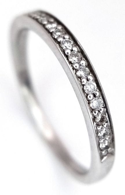 A 9K WHITE GOLD, DIAMOND SET, HALF ETERNITY RING. 