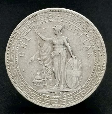 Un dólar de plata británico de 1899. Grado EF.