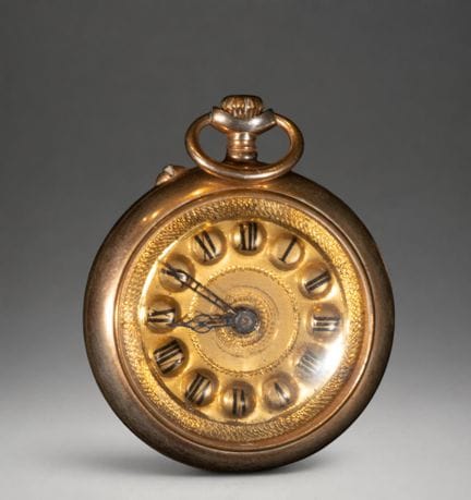 Gold pocket watch with an ornate dial
Pocket watch