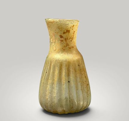 Blown-glass unguentarium with a fluted body. Roman