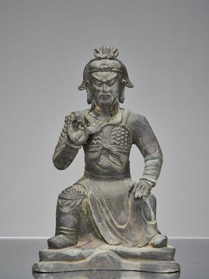 EINE CHINESISCHE BRONZEFIGUR VON GUAN YU IN SITZEN
