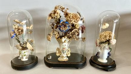 A bridal display consisting of three glass globes 