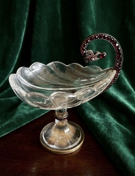 Glass stemmed cup in a shell shape, set in a metal