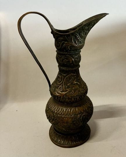 Brass ewer decorated with friezes and arabesques