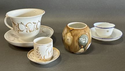 Set of three cups with saucers and a pot featuring