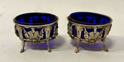 Pair of oval silver plated salt cellars decorated 