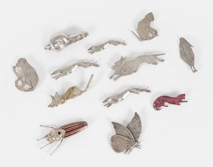 Twelve animal-themed brooches (two monkeys, three 