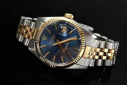 劳力士“蚝式恒动日历型”不锈钢与750黄金腕表，自动上链，蓝色表盘，金色条形时标，有机玻璃表镜，凹槽