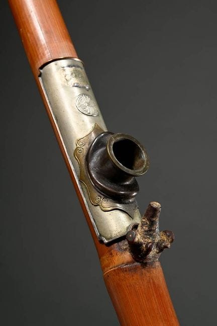 Antique opium pipe made from a bamboo tube with ja
