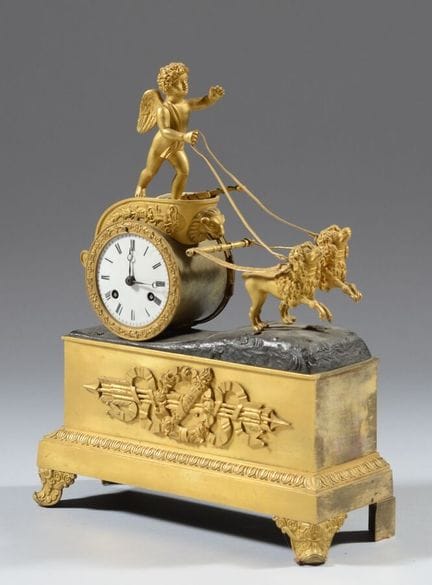 A gilded and patinated bronze clock in the shape o