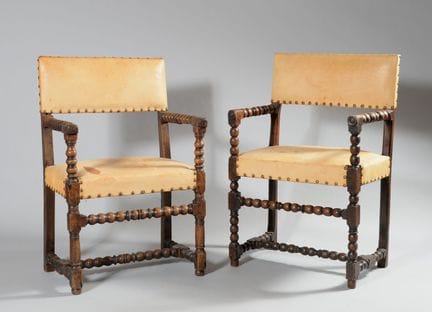 Two armchairs in turned walnut, with the legs join