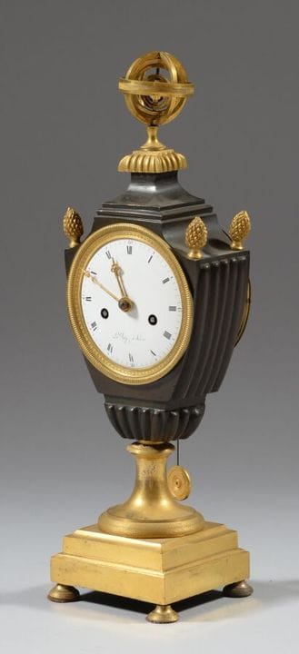 A gilded and patinated bronze clock in the shape o