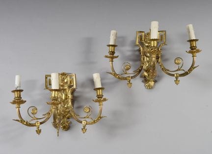 Pair of bronze wall sconces decorated with foliage