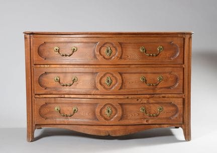 A chest of drawers with a slightly curved front ma