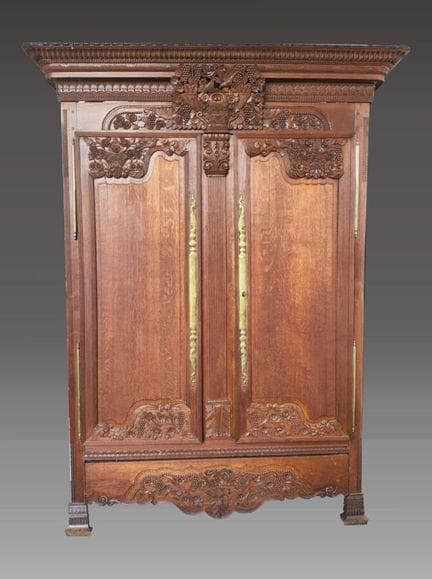 A molded and richly carved oak cabinet with a stra