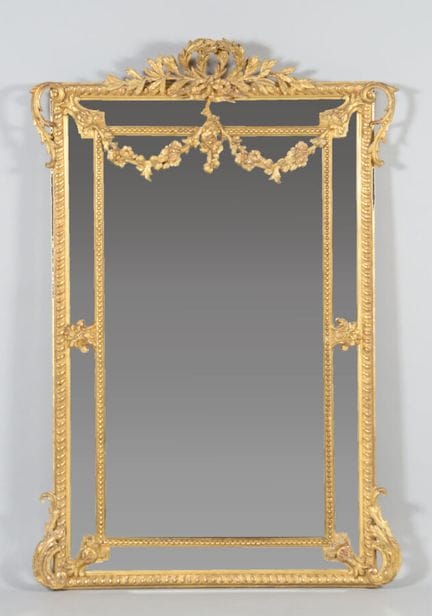 A wooden and gilded stucco cabinet with a closed f