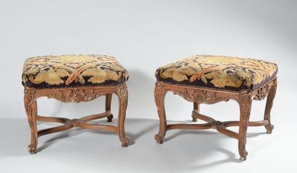 A pair of large beechwood stools richly carved wit