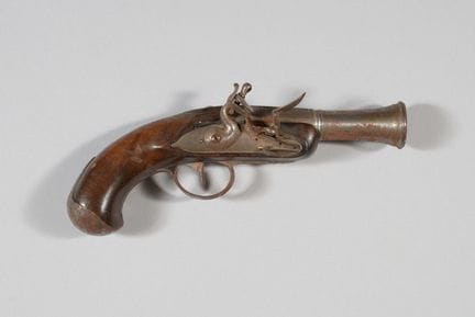 Flintlock pistol with a walnut stock decorated wit