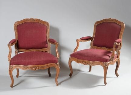 A pair of large armchairs with flat backs and a mo