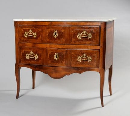 A chest of drawers with a slightly curved front ma