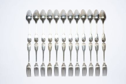 A set of twelve pieces of silverware and one teasp